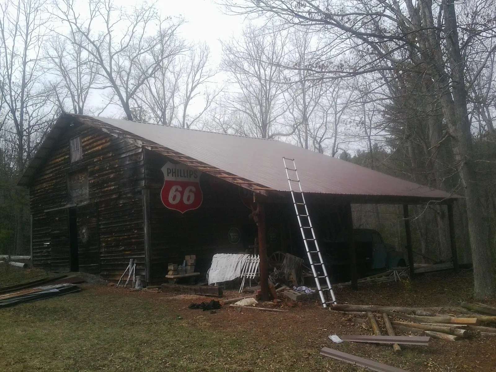 New metal roof on an open sided timber barn with a vintage sign in Saginaw